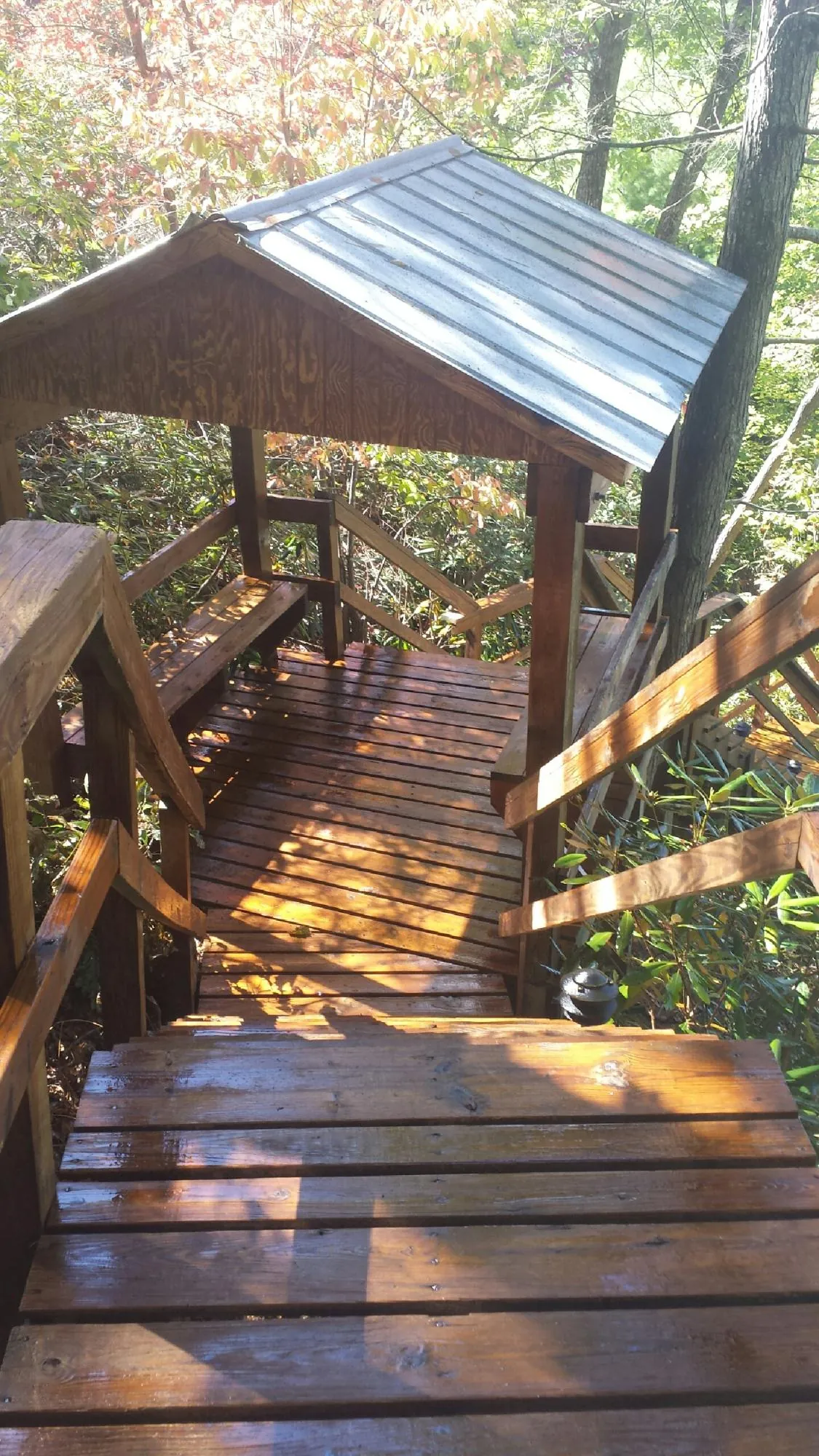 Freshly stained wood walkway and covered shelter with a metal roof in Carlisle
